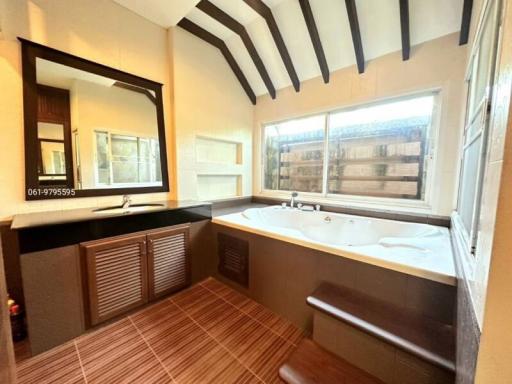 Spacious bathroom with large tub and wooden accents