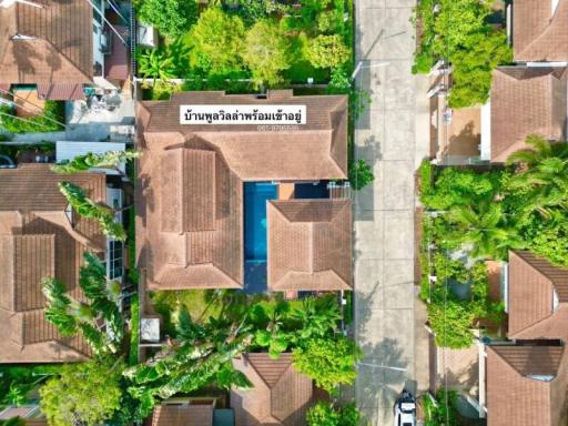 Aerial view of a residential property with prominent swimming pool