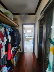 View of a bedroom closet leading towards an en-suite bathroom