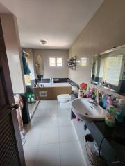 Spacious bathroom with various toiletries and a bidet