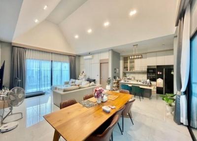 Modern open-plan living, dining and kitchen space with tasteful decor