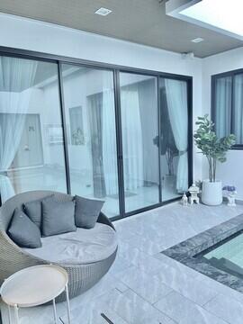 Modern living area with glass doors overlooking a pool