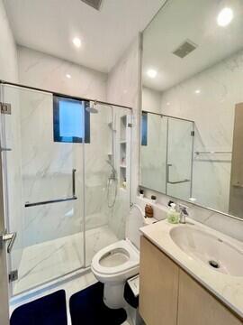Modern bathroom with glass shower and white interior