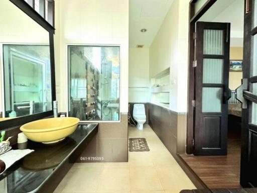 Modern bathroom with dual sinks and glass shower partition