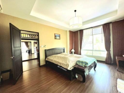 Spacious bedroom with queen-sized bed and large window