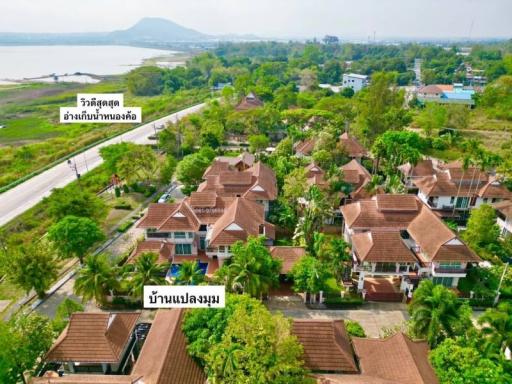 Aerial view of a residential area with multiple houses and green surroundings