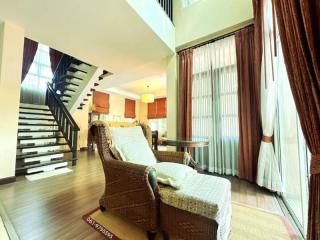 Elegant living room with staircase and high ceiling