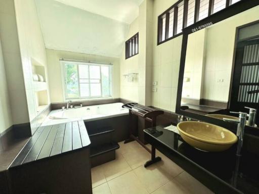 Spacious bathroom with a large bathtub and modern fixtures