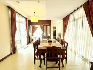 Spacious dining room with large windows and ample natural light