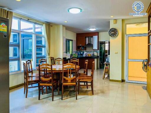 Spacious dining area with adjacent kitchen in a modern home