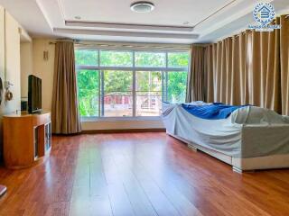 Spacious bedroom with large windows and hardwood floors