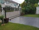 Spacious front yard with driveway and sliding gate