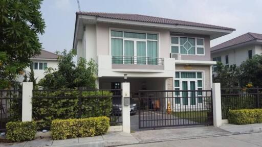 Two-storey residential house with a balcony and driveway