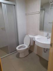 Compact modern bathroom with toilet and sink