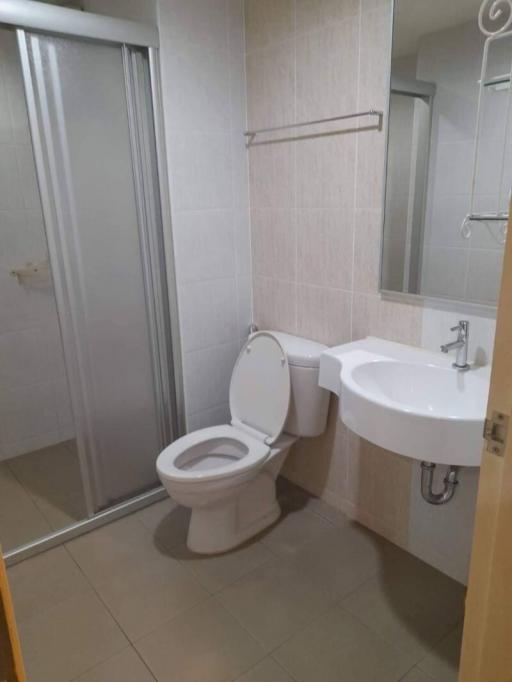 Compact modern bathroom with toilet and sink