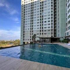 Swimming pool with high-rise residential building in the background