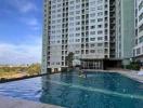 Swimming pool with high-rise residential building in the background