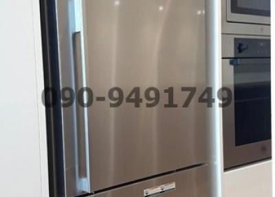 Modern stainless steel refrigerator in kitchen setting