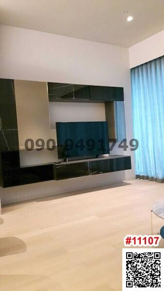 Spacious living room with modern entertainment wall unit and light wooden flooring