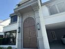 Elegant entrance of a modern residential building with a grand front door