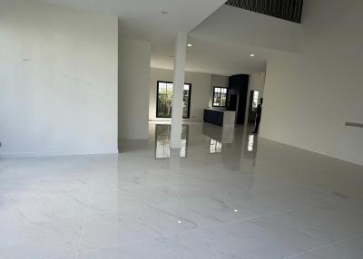 Spacious and bright empty interior of a modern building with glossy floor tiles and high ceiling