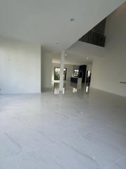 Spacious and bright empty interior of a modern building with glossy floor tiles and high ceiling