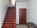 Elegant wooden staircase with white walls in a modern home interior