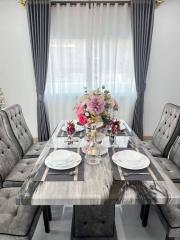 Elegant dining room with set table and stylish chairs