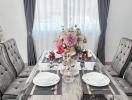 Elegant dining room with set table and stylish chairs