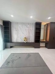 Modern living room with marble wall and sleek built-in shelving units