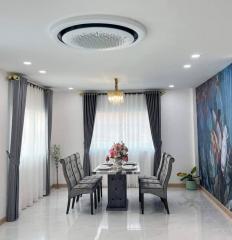 Elegant dining room with modern chandelier and floral accent wall