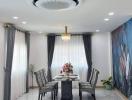 Elegant dining room with modern chandelier and floral accent wall