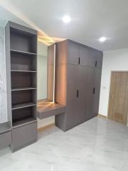 Modern bedroom with built-in wardrobe and marble flooring