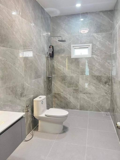 Modern bathroom with grey tiles and white fixtures