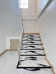 Modern staircase in a residential home with unique black and white design