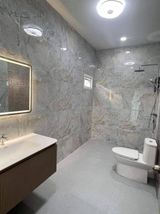Modern bathroom with gray marble walls and sleek fixtures