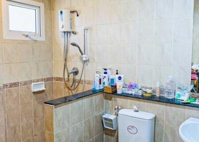 Modern bathroom with wall-mounted shower and toiletries