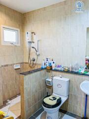 Modern bathroom with wall-mounted shower and toiletries