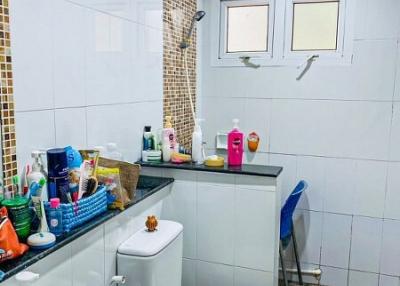 Modern bathroom with white tiles and essential amenities