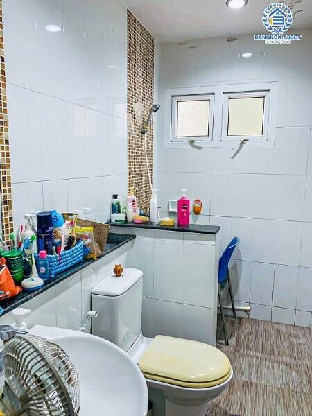 Modern bathroom with white tiles and essential amenities