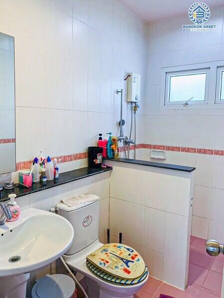 Compact bathroom with sink, mirror, and washing machine