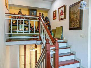 Elegant wooden staircase with under-stair lighting in a well-decorated home