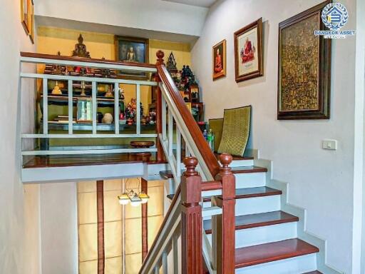 Elegant wooden staircase with under-stair lighting in a well-decorated home