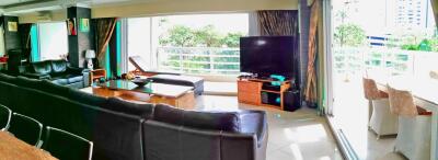Spacious living room with modern furnishings and balcony access