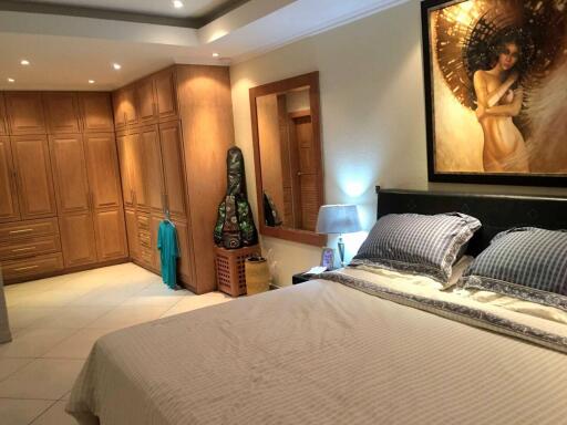 Cozy Bedroom with Large Wardrobe and Artistic Decor