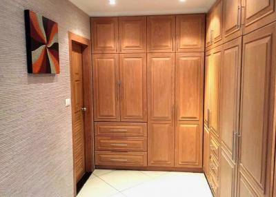 Spacious hallway with built-in wooden storage cabinets