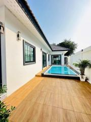 Modern home exterior with swimming pool and wooden decking