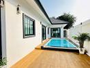 Modern home exterior with swimming pool and wooden decking