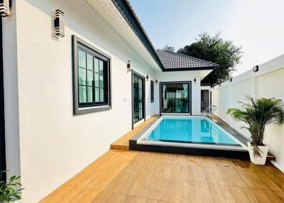 Modern home exterior with swimming pool and wooden decking