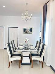 Elegant dining room with a chandelier and set table